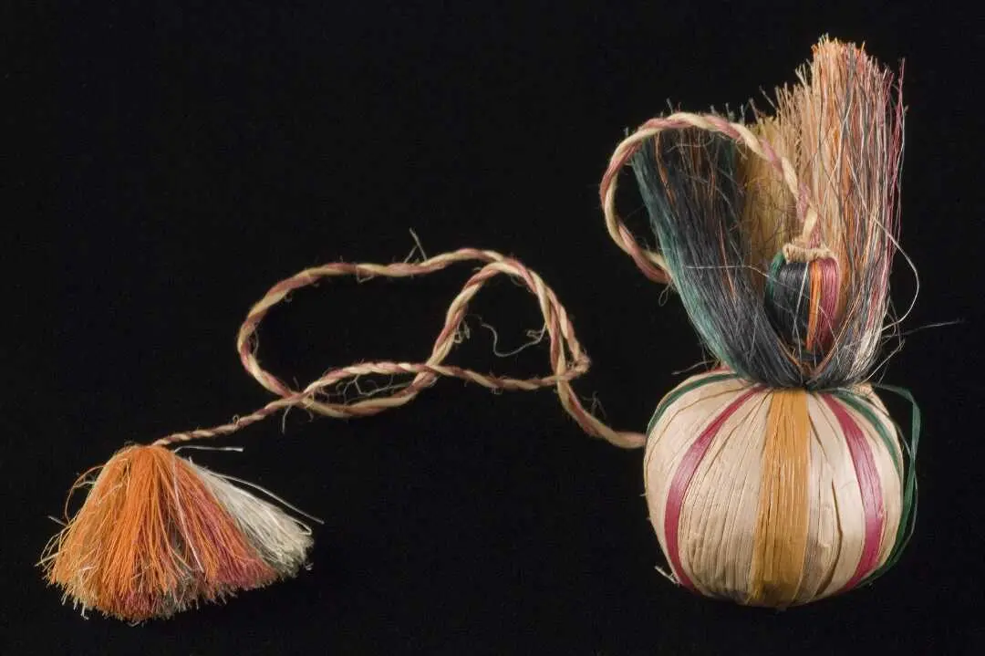 Poi with coloured stripes and long plaited, fringed tassel. 