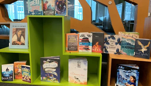 Some of Services to Schools staff's favourite books published in 2020 displayed on a book stand.
