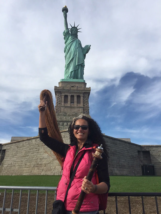 Selina Tusitala Marsh standing in front of The Statue of Liberty.