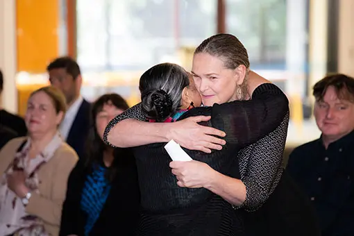 Two women hugging. 