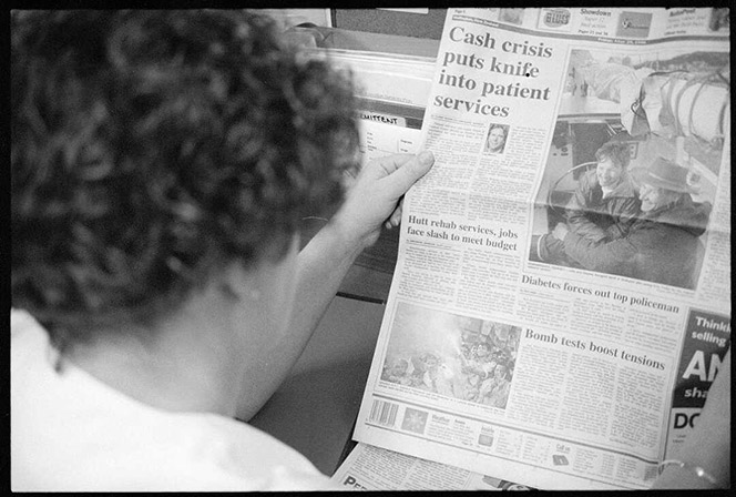 Person reading a newspaper.
