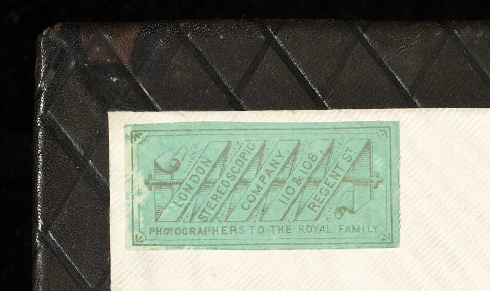 Greenish sticker on the inner cover of the photo album showing where it was bound: London Stereoscopic Company.
