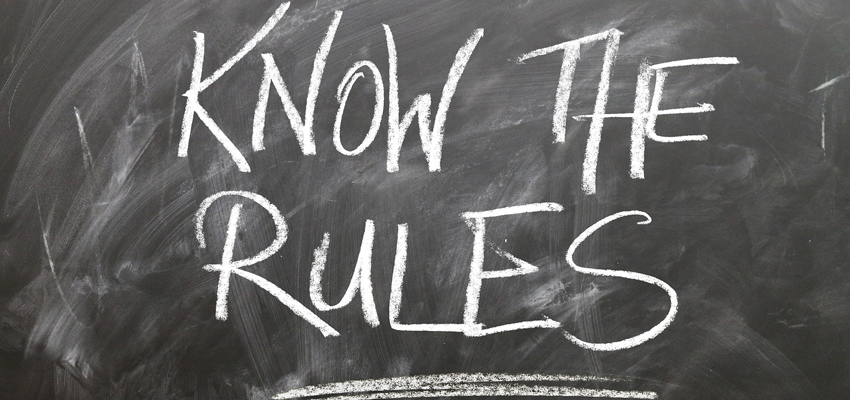 Blackboard with 'KNOW THE RULES' written on it