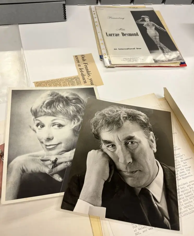 An array of manuscript materials including black and white portrait photos and a pamphlet with the title "Presenting Miss Lorrae Desmond — an international star".