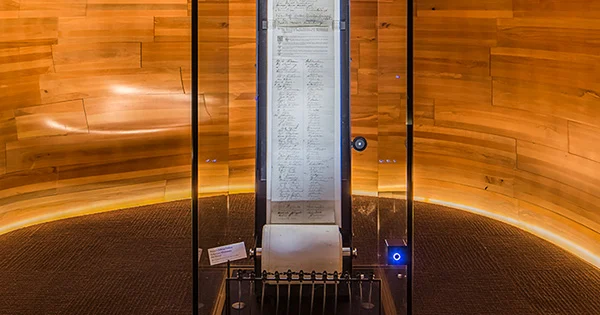 The 1893 Women's Suffrage Petition on display in a glass case.