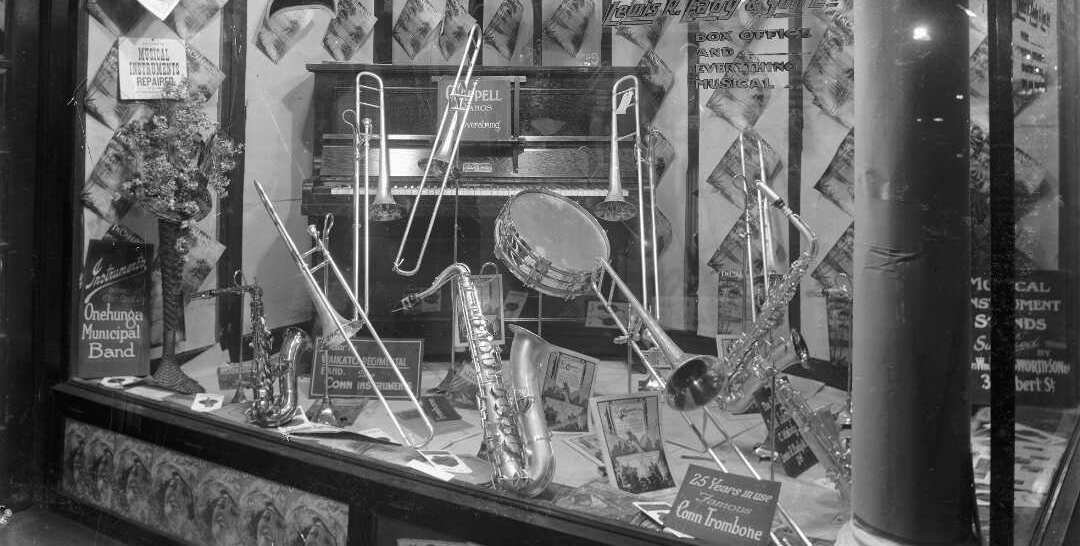 Brass and wind instruments in a music store window. 
