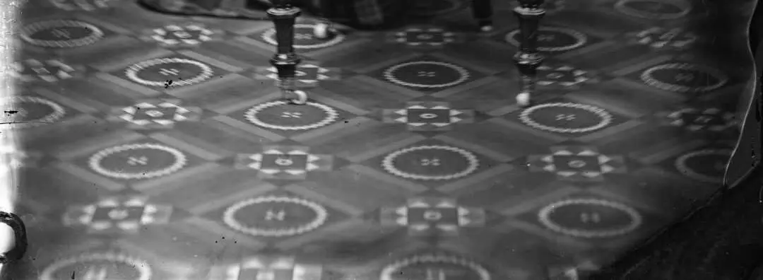 Black and white photo of patterned carpet.