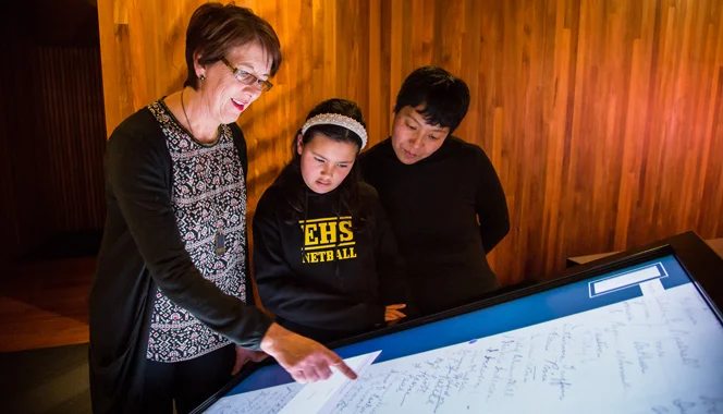 Teacher and student using the He Tohu Suffrage Petition interactive display.