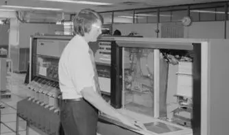 Man operating large computer in 1975.