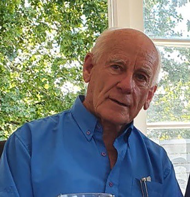 Headshot of a man wearing a blue shirt.