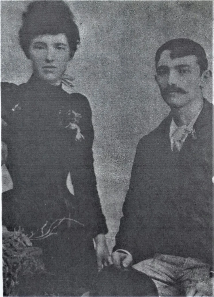 A blurry black and white photo of a man and woman seated besides one another.