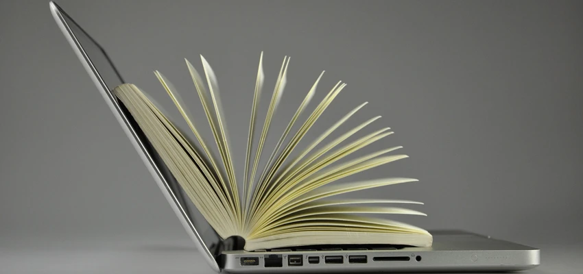 Open book inside an open laptop.