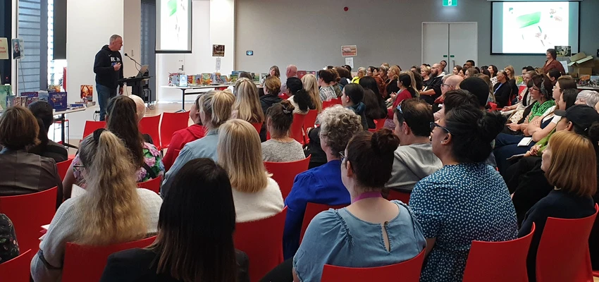 Author David Riley presenting about reading to school staff.