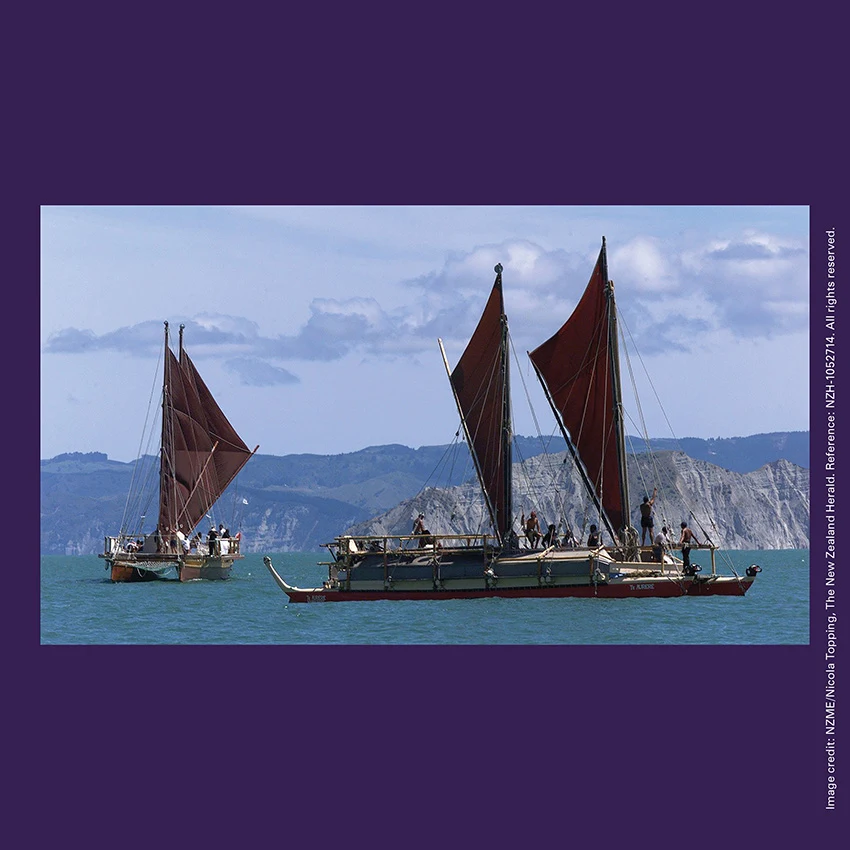 Front of curiosity card TMCC2 with image of waka hourua (double-hulled canoe) Te Aurere being greeted in Tūranganui-a-Kiwa / Poverty Bay.