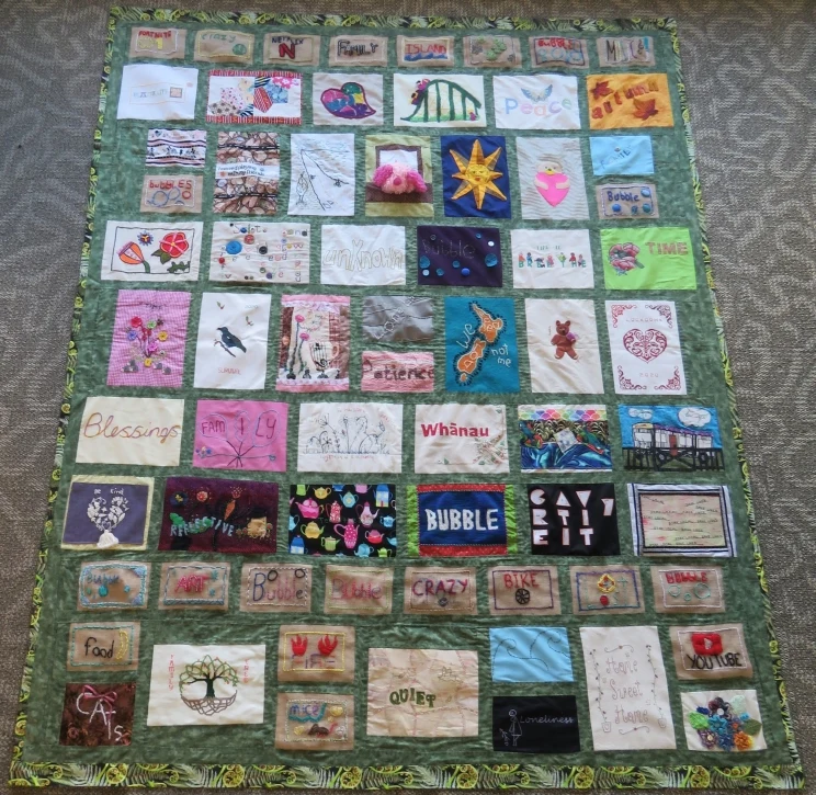 A quilt made with various patches and squares of handmade fabric, each one different from the next.