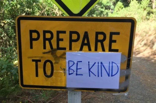 Road sign ‘Prepare to stop’ which has been changed to read: 'Prepare to be kind'. 