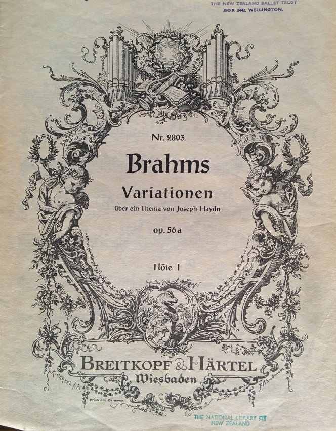 Front illustration on score for Variationen über ein Thema von Joseph Haydn, showing cherubs and musical instruments.