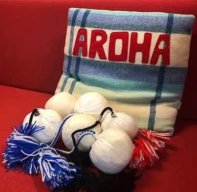 Cushion with word aroha and 6 poi. 