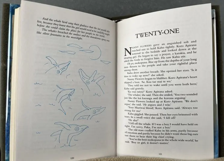 A page of annotations showing a pod of hand-drawn whales breaching with sea birds seen in the air around them. 