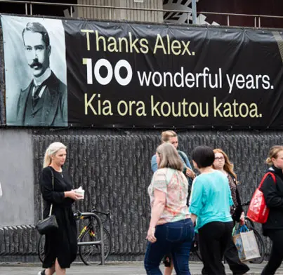 Banner outside the National Library building with a photo of Alexander Turnbull and the words "Thanks Alex. 100 wonderful years. Kia ora koutou katoa. 