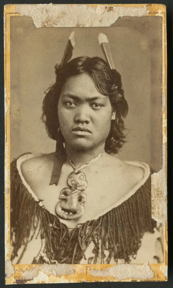 Portrait of a woman from the Aperahama family of Manaia, with a hei tiki, cloak, and feathers.