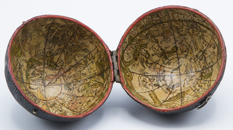 Globe case open with markings on the inside.