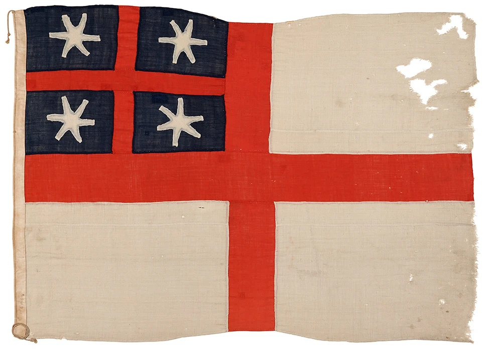 Colour photograph of the flag of the United Tribes of New Zealand. It shows 4 stars and a small red cross inside the first quarter of a large red cross.