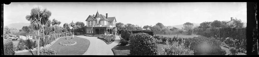 Panoramic photo of a house and garden.