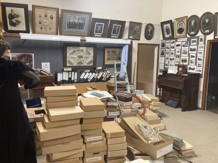 A room filled with a variety of historic items and photographs.