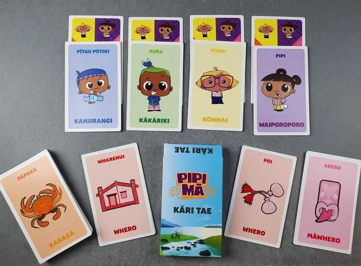 An array of colourful playing cards with images and their corresponding Māori words.