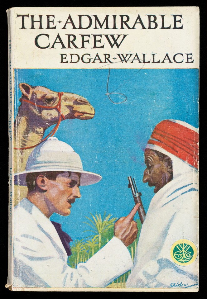 Cover of The Admirable Carfew, showing a fairly colonialist scene of a European man and a Middle Eastern man. A camel looks on.