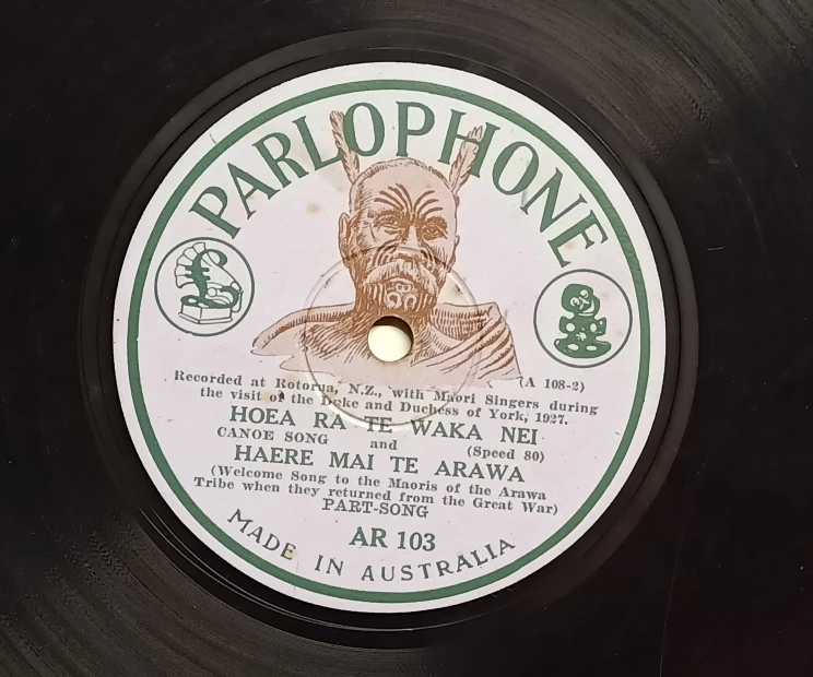 A close-up of the label of a record with the 'Parlophone' brand printed in large letters along with a Māori chief shown in the middle surrounded by text of the album information.