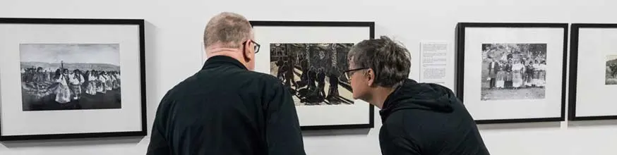 People looking at the Pūkana exhibition. 