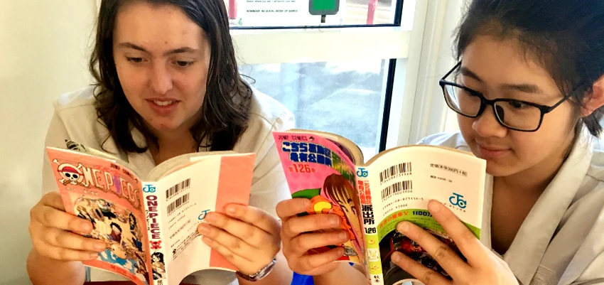 Secondary school students reading books from a responsive school library collection