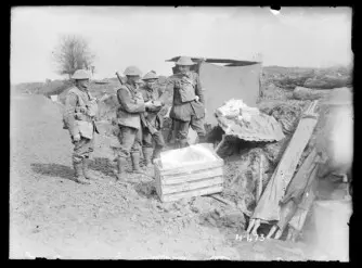 The Padre of the New Zealand Rifle Brigade operating a makeshift wayside canteen.