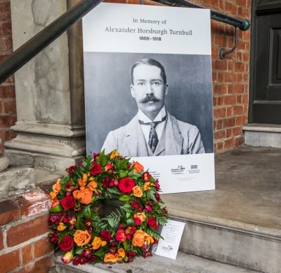 Image of Alexander Turnbull and a wreath outside Turnbull House.