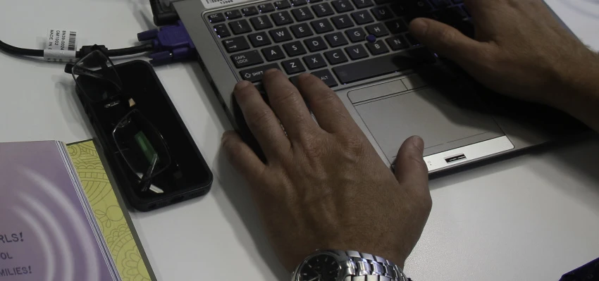 An individual using a laptop.