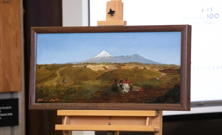 Oil painting of Mt Taranaki in the distance with a small group of people sitting on the ground in a field in the foreground.