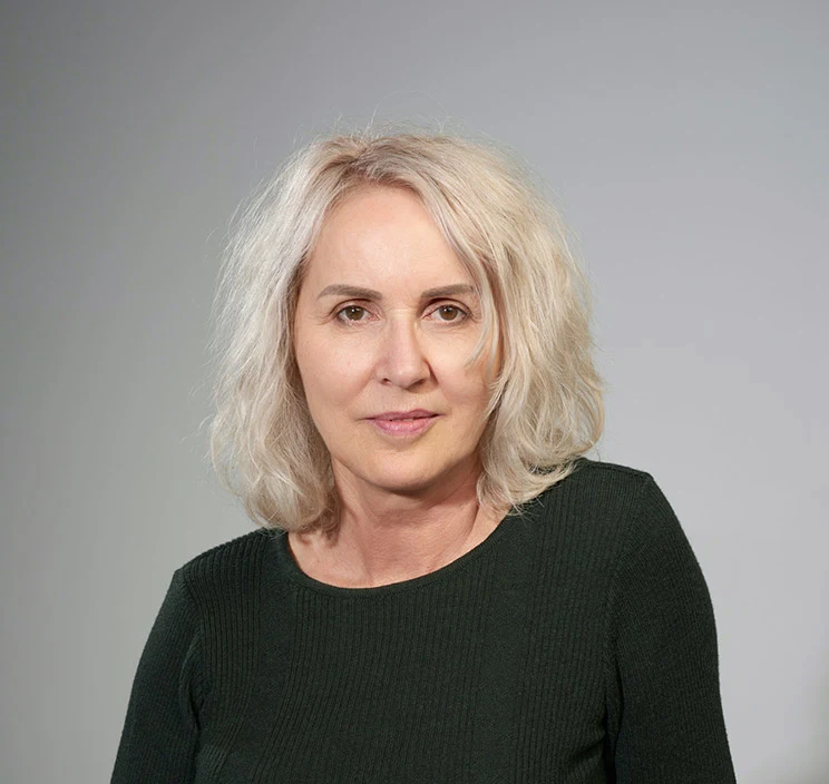 Portrait of blonde woman wearing a black top.