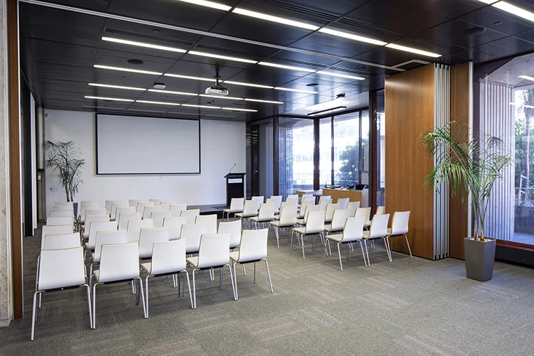 Rooms set up with chairs facing a podium.