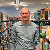Alan Dingley between shelving at the National Library Auckland centre.