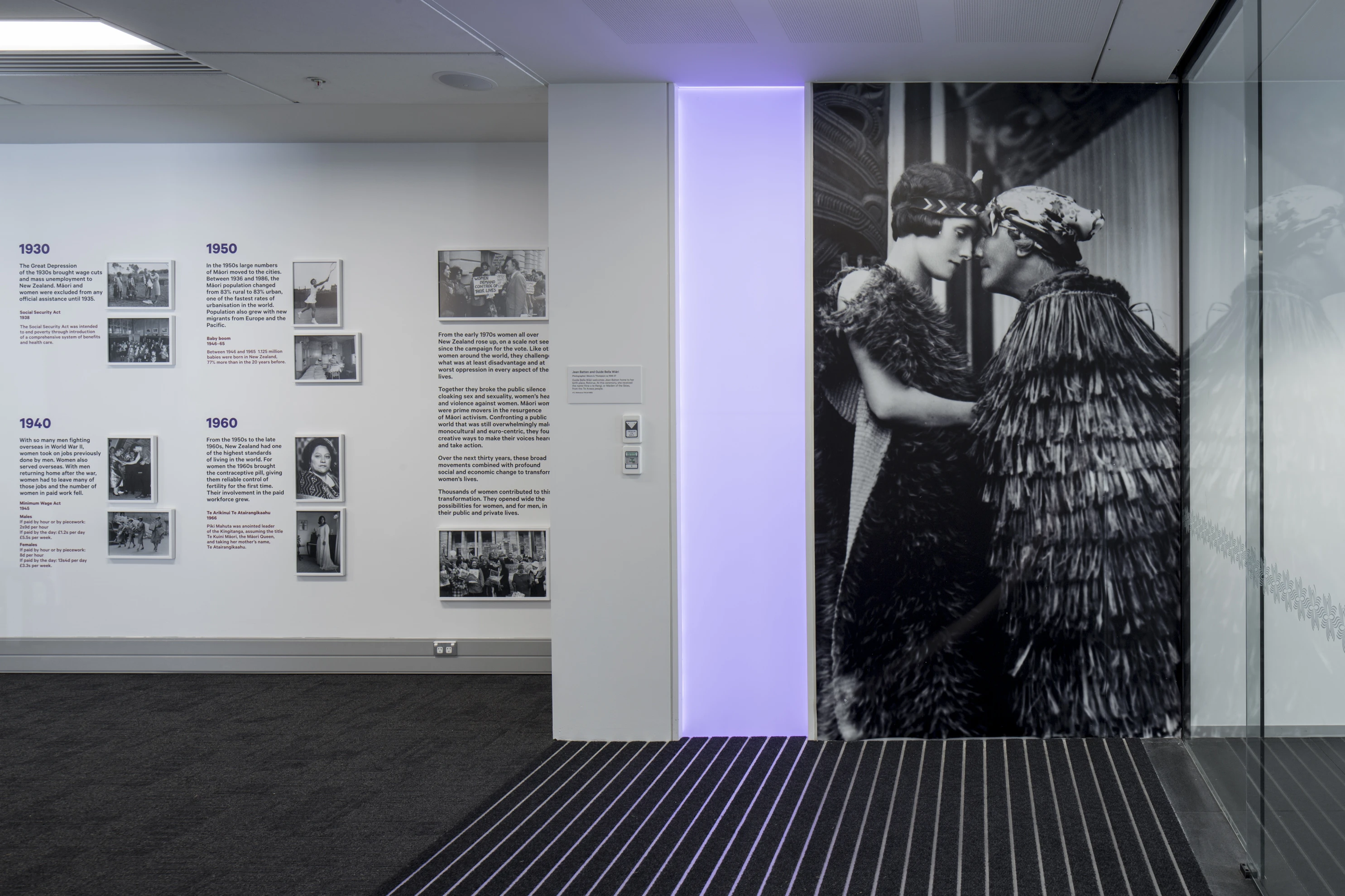 Photograph of an exhibition including a large photograph of Guide Bella greeting Jean Batten.