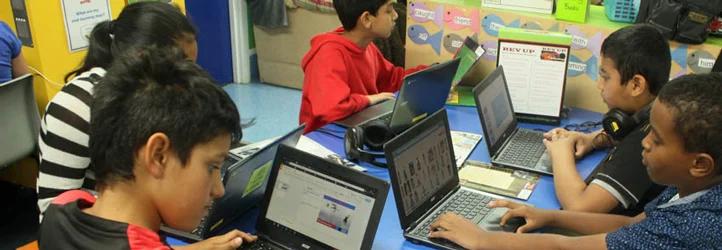 Students using laptops in the classroom