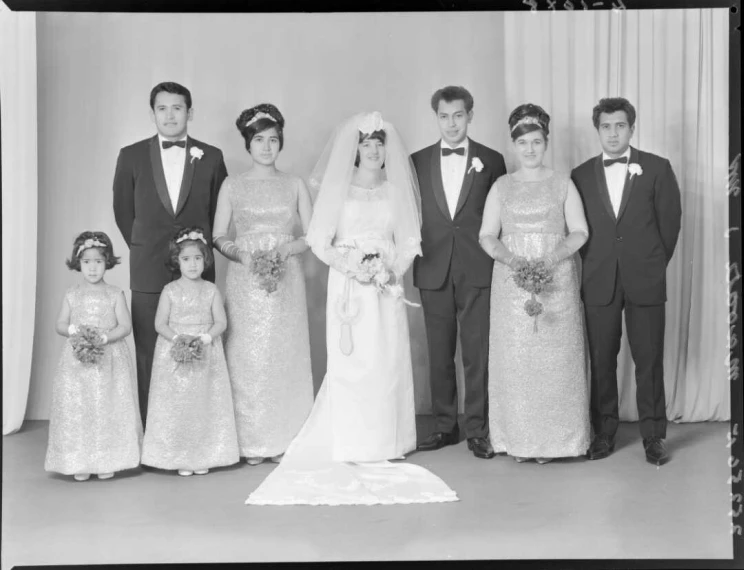 A formal group portrait of a wedding bride and her family.