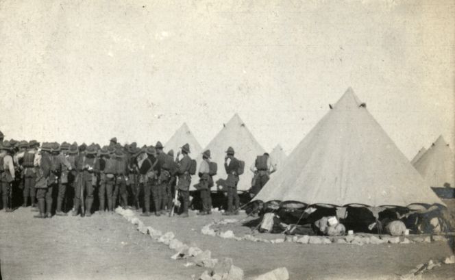 Soldiers gathering around to hear an announcement in the tent lines, Zeitoun Camp, 1915.