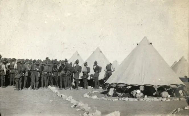 Soldiers gathering around to hear an announcement in the tent lines, Zeitoun Camp, 1915. 