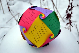 A modular kirigami curved surface piece, a rhombic dodecahedral 2013 globe calendar.