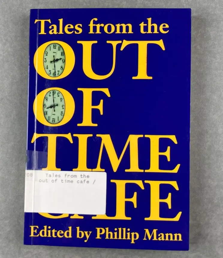 The cover of a book shows a blue background with large, yellow lettering with clocks appearing in both 'O' in "Out Of Time".