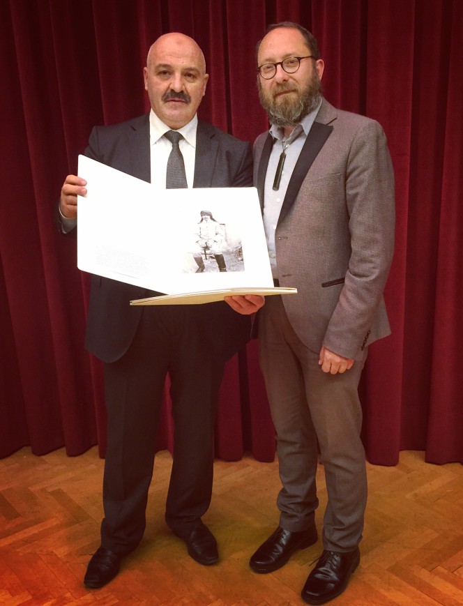 Corin Haines presents a photographic print from the Alexander Turnbull Library to a representative from the National Library of Turkey.