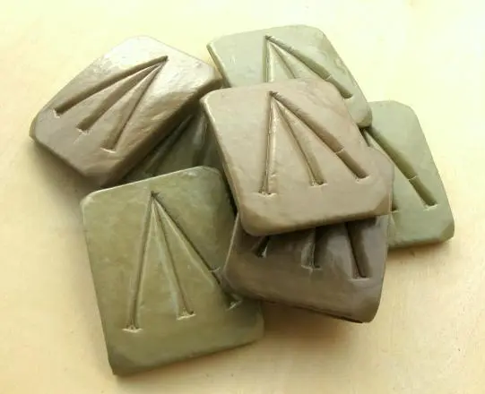 Colour photograph of replica portable soup blocks marked with a 3-pronged arrow.